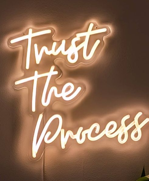 neon sign of trust the process
